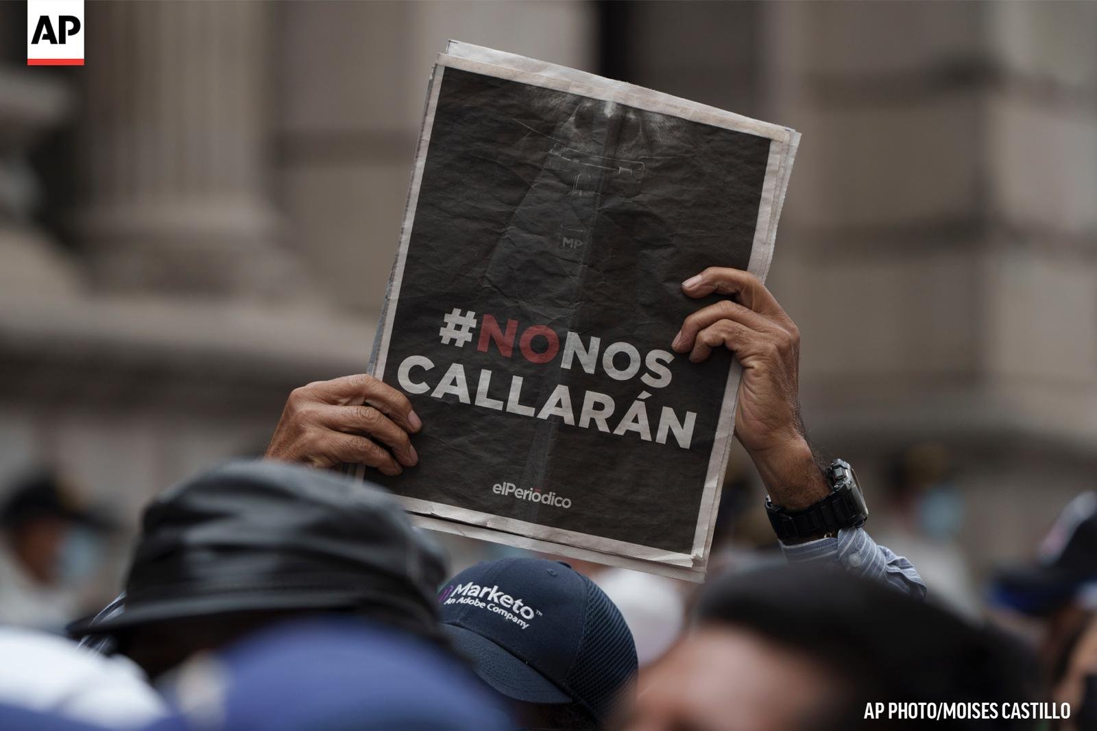 En una manifestación, una persona alza una portada de elPeriódico con el titular «#NoNosCallarán». Foto: AP / Moisés Castillo.